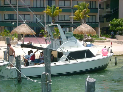 31 ft. Bertram fishing charter boat at the dock in Cancun