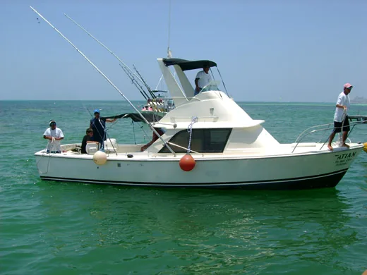 31 ft. Bertram private fishing charter boat on the water in Cancun