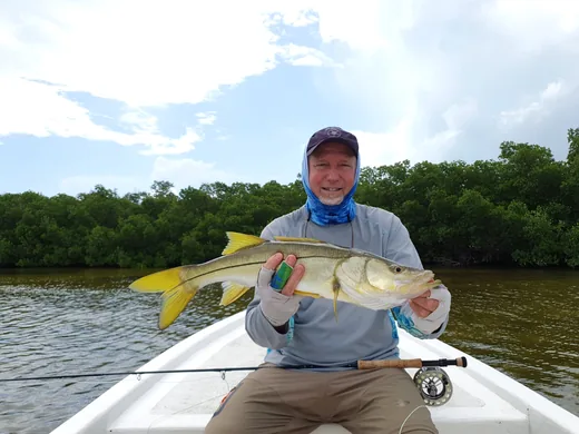 Angler holding a snook caught while fishing in the Cancun Lagoon