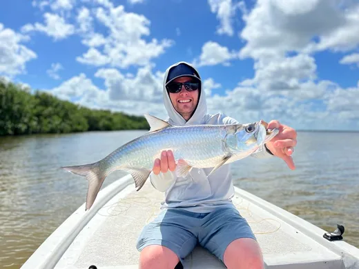 Angler holding a tarpon caught in the Cancun Lagoon