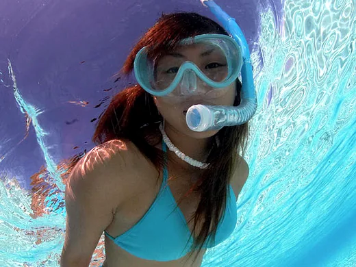 Snorkeler swimming in the clear waters of Cancun