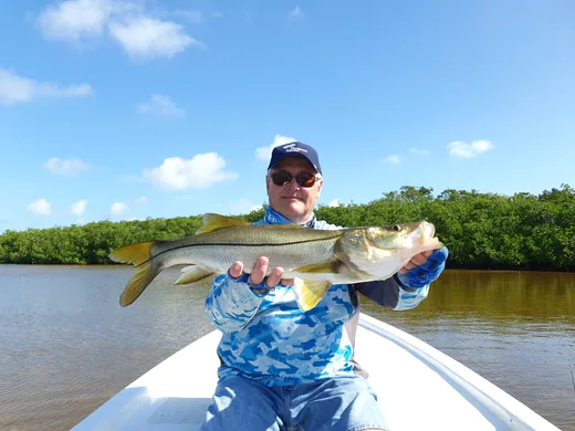 Angler holding a snook caught while fishing at Isla Blanca